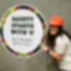Woman pointing at a sign, "Safety Starts With 'S'" with safety message.